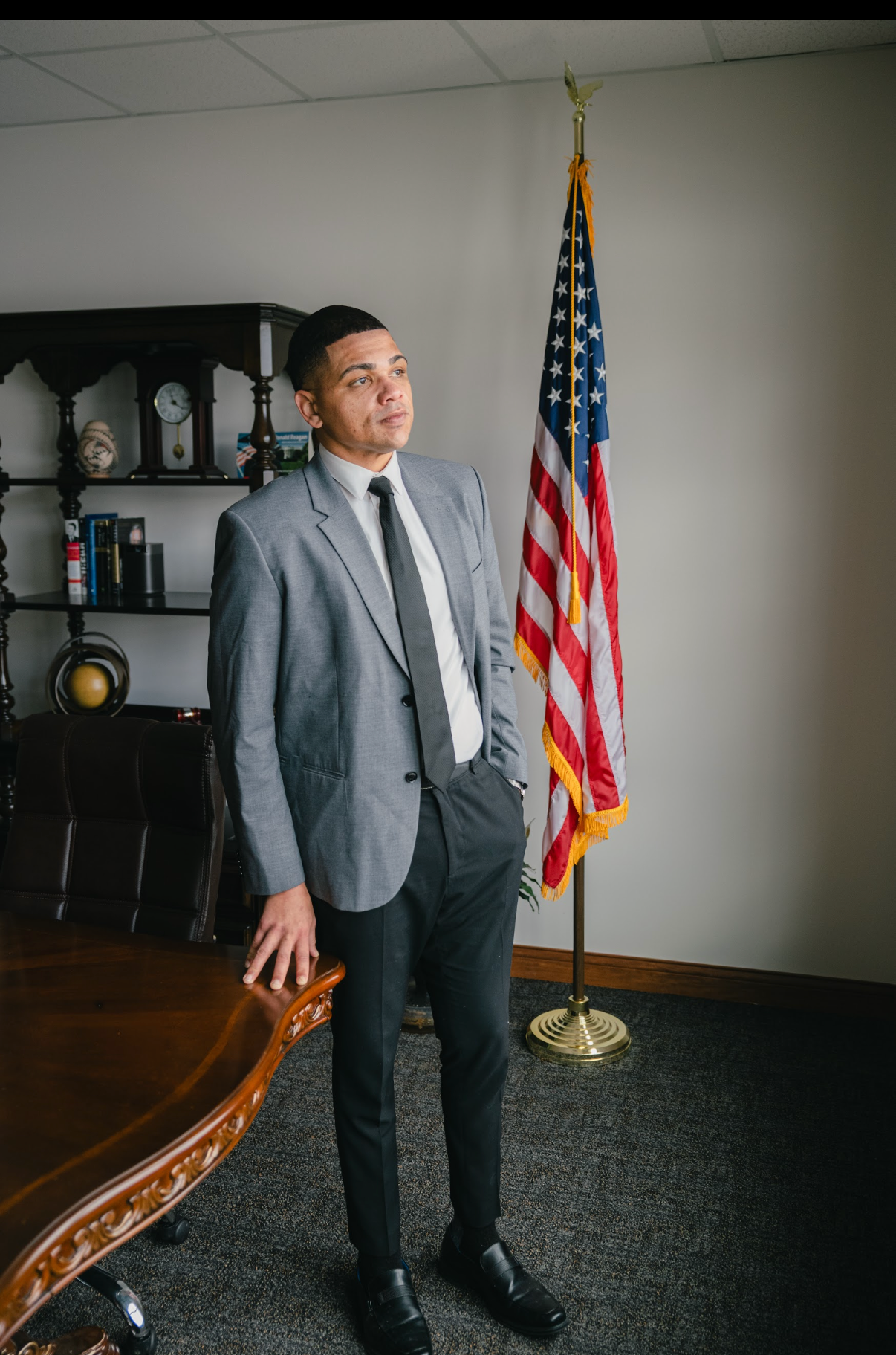 Attorney Matt Lawson standing in his office beside an American flag